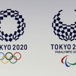 The Tokyo Organizing Committee of the Olympic and Paralympic Games displays the new official logos of the 2020 Tokyo Olympics, left, and the 2020 Tokyo Paralympic Games. Organizers unveiled the new official logo of the 2020 Tokyo Olympics on Monday, April 25, opting for blue and white simplicity over more colorful designs. The winning logo, selected from four finalists, is entitled Harmonized Checkered Emblem. It features three varieties of indigo blue rectangular shapes to represent different countries, cultures and ways of thinking. (AP Photo/Shizuo Kambayashi)